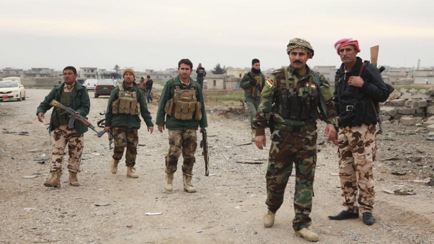 Members of the Kurdish security forces take part in a patrol in Zumar, Nineveh province December 18, 2014. Kurdish peshmerga fighters have fought their way to Iraq's Sinjar mountain and freed hundreds of people trapped there by Islamic State fighters, a Kurdish leader said on Thursday. Kurdish peshmerga soldiers began their offensive on Wednesday to break the jihadists' siege of the mountain and the town of Sinjar. The peshmerga advanced from Zumar, east of Sinjar, capturing back 700 square km (270 square m