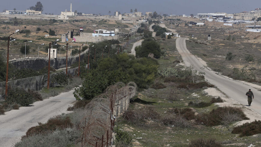A member of Palestinian security forces patrols near the border between Egypt and Gaza, in Rafah in the southern Gaza Strip January 3, 2015. Egyptian border troops shot dead a Palestinian youth as he tried to cross illegally from the Gaza Strip on Friday, Palestinian and Egyptian sources said. REUTERS/Ibraheem Abu Mustafa (GAZA - Tags: POLITICS CIVIL UNREST) - RTR4JYK4