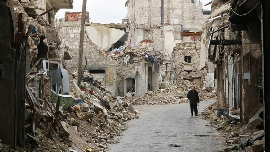 A man walks through a damaged street beside a frontline in Old Aleppo January 4, 2015. REUTERS/Hosam Katan (SYRIA - Tags: POLITICS CIVIL UNREST CONFLICT) - RTR4K1CI