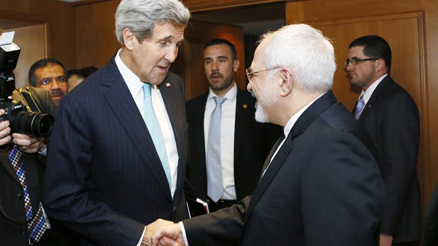 U.S. Secretary of State John Kerry shakes hands with Iranian Foreign Minister Mohammad Javad Zarif before a meeting in Geneva January 14, 2015. Zarif said on Wednesday that his meeting with Kerry was important to see if progress could be made in narrowing differences on his country's disputed nuclear program.  REUTERS/Rick Wilking (SWITZERLAND - Tags: POLITICS) - RTR4LDW2