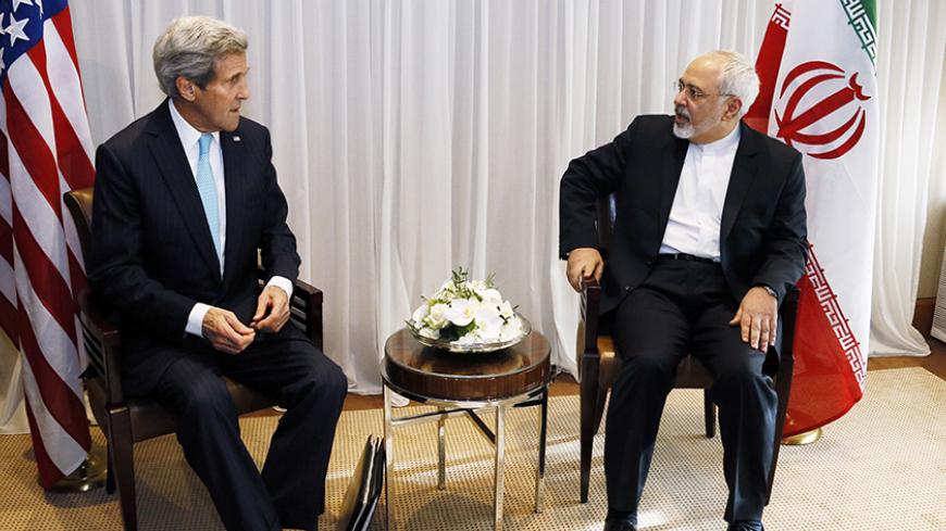 U.S. Secretary of State John Kerry sits with Iranian Foreign Minister Mohammad Javad Zarif before a meeting in Geneva January 14, 2015. Zarif said on Wednesday that his meeting with Kerry was important to see if progress could be made in narrowing differences on his country's disputed nuclear program. REUTERS/Rick Wilking (SWITZERLAND - Tags: POLITICS) - RTR4LDWK