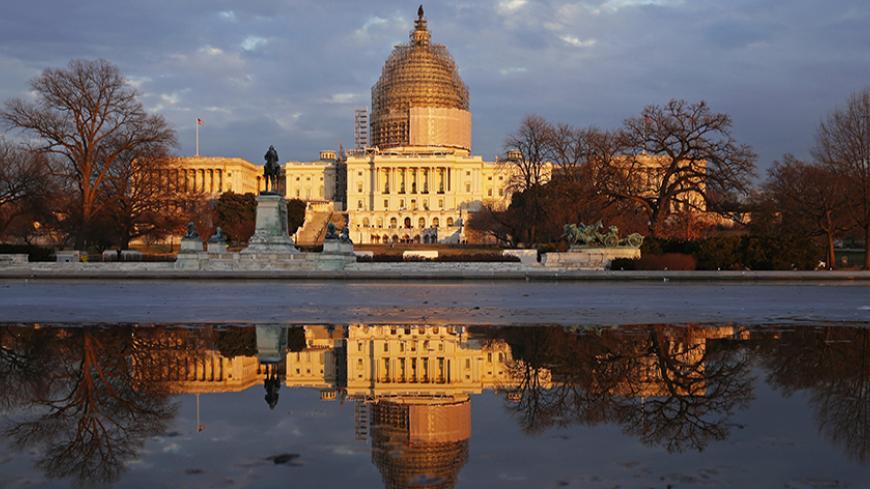 Awash in the golden light of sunset, the U.S. Capitol casts its image upon the Reflecting Pool in Washington January 20, 2015. U.S. President Barack Obama delivers his State of the Union address to a joint session of the U.S. Congress in the Capitol this evening. 
REUTERS/Kevin Lamarque  (UNITED STATES - Tags: POLITICS) - RTR4M7V7