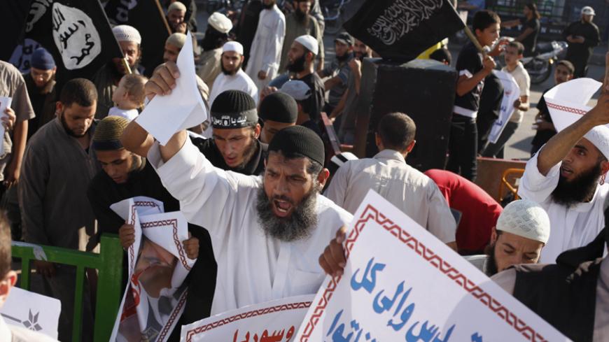 Palestinian Salafists shout slogans during a rally in protest of what they say are recent massacres committed against Syrian and Egyptian people and against Syria's President Bashar al-Assad and Egypt's army chief General Abdel Fattah al-Sisi, in Rafah in the southern Gaza Strip August 22, 2013. REUTERS/Ibraheem Abu Mustafa (GAZA - Tags: POLITICS CIVIL UNREST) - RTX12TCB