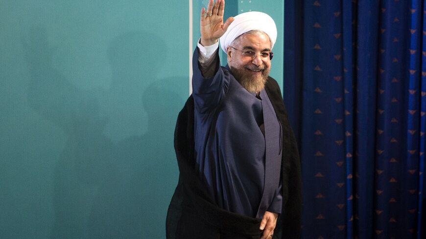 Iranian President Hassan Rouhani waves as he leaves a press conference in Tehran on August 30, 2014. Iran accused the United States of duplicity for imposing new sanctions on organisations linked to Tehran's nuclear programme, despite long-running but active negotiations to end the standoff. AFP PHOTO/ BEHROUZ MEHRI (Photo credit should read BEHROUZ MEHRI/AFP/Getty Images)