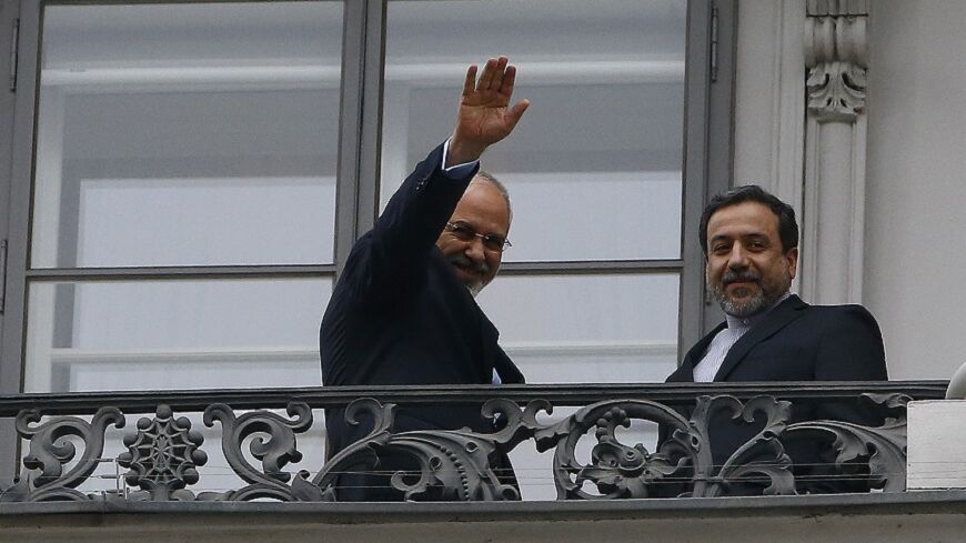 Iranian Foreign Minister Javad Zarif (L) and Abbas Araghchi, Iran's chief nuclear negotiator, stand on the balcony of Palais Coburg during a meeting between Iran and six world powers in Vienna November 22, 2014. Iran, the United States, Britain, France, Germany, Russia and China began the final round of negotiations on a nuclear deal on Tuesday. Officials close to the talks have said the two sides are unlikely to secure a final agreement and may need to extend the negotiations. REUTERS/Leonhard Foeger