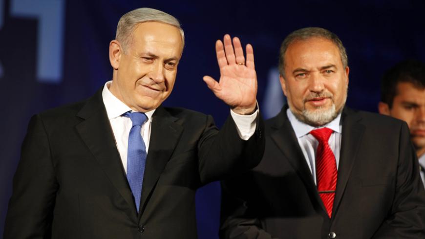 TEL AVIV, ISRAEL - JANUARY 23: (ISRAEL OUT) Israeli Prime Minister Benjamin Netanyahu waves to supporters with Former Israel Minister for Foreign Affairs Avigdor Liberman  at his election campaign headquarters on Janurary 23, 2013 in Tel Aviv, Israel. Netanyahu was re-elected for a third term and will return to office, according to exit polls. Israel had the highest turnout of voters since 1999. (Photo by Lior Mizrahi /Getty Images)