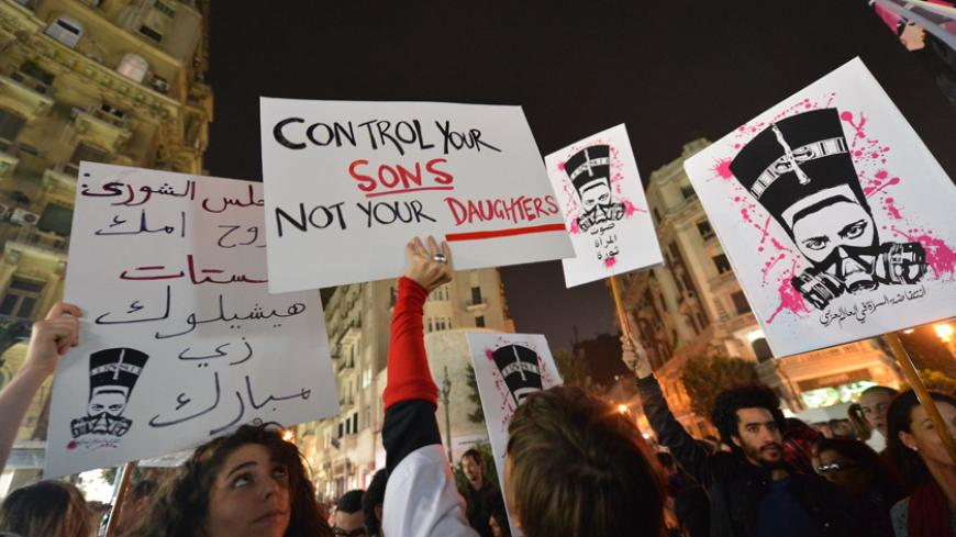 Egyptian protesters hold up placards and shout slogans during a demonstration in Cairo against sexual harassment on February 12, 2013. Egyptian protesters took to the street again to demand an end to sexual violence, as campaigns against the repeated attacks in central Cairo pick up steam. Sexual harassment has long been a problem in Egypt, but recently the violent nature and frequency of the attacks have raised the alarm.   AFP PHOTO / KHALED DESOUKI        (Photo credit should read KHALED DESOUKI/AFP/Gett