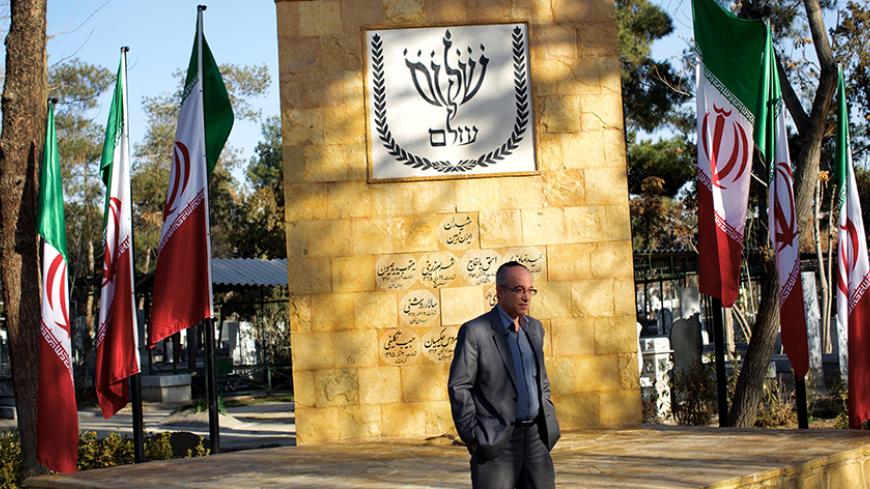 TO GO WITH AFP STORY BY CYRIL JULIEN
Homayoun Sameyah Najaf Abadi, head of Iran's 8,500-strong Jewish community, poses in front of a new memorial for Iran's Jewish people engraved with 10 names -five died fighting in the 1980-88 war against Iraq, three were killed by Saddam Hussein's bombing of Tehran and the other two died in the tumultuous early days of the revolution that ended the shah's rule- at the Beheshtieh Jewish cemetery in southern Tehran, on January 9, 2015. The eight-acre space in south Tehran