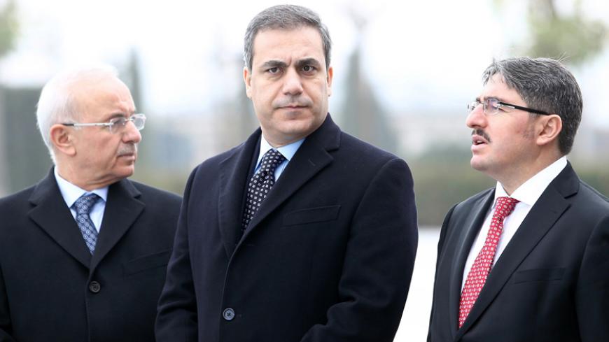 This file picture taken on December 19, 2014 shows the head of Turkey's intelligence agency Hakan Fidan (C) standing in Ankara. The powerful head of Turkey's intelligence agency, one of the most loyal allies of President Recep Tayyip Erdogan, has resigned to stand for election as a lawmaker, the official Anatolia news agency said on February 7, 2015. The resignation of Hakan Fidan, who has headed the National Intelligence Agency (MIT) since 2010, has been accepted by Prime Minister Ahmet Davutoglu and will