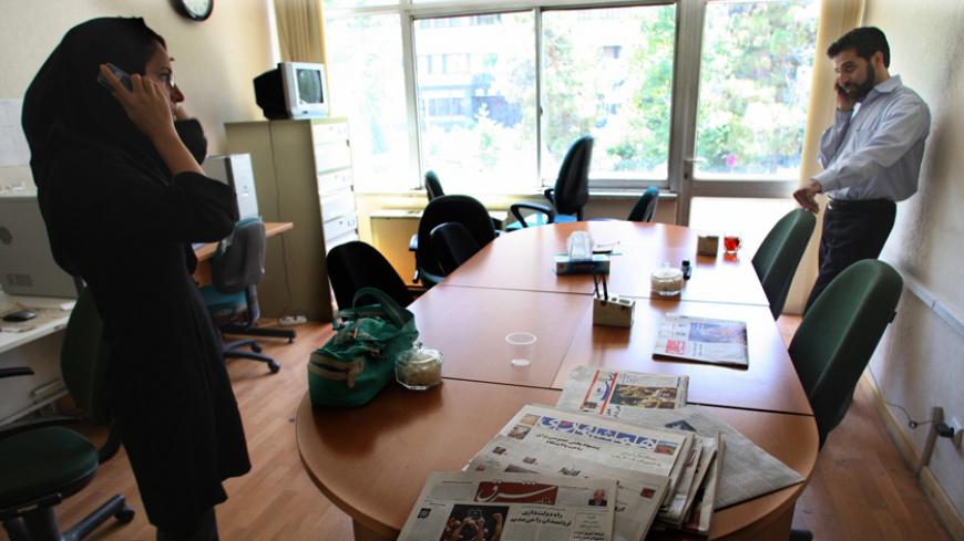 Iranian journalists of leading moderate daily, Shargh (East), stand by their desks 06 August 2007 in Tehran after it was shut down for the second time in less than a year for publishing an interview with a woman accused of being a homosexual activist. The ban on Shargh (East), the favourite newspaper of Iranian liberals, comes amid growing pressure on the press in Iran and follows the closure of fellow moderate daily Ham Mihan last month. AFP PHOTO/ATTA KENARE (Photo credit should read ATTA KENARE/AFP/Getty