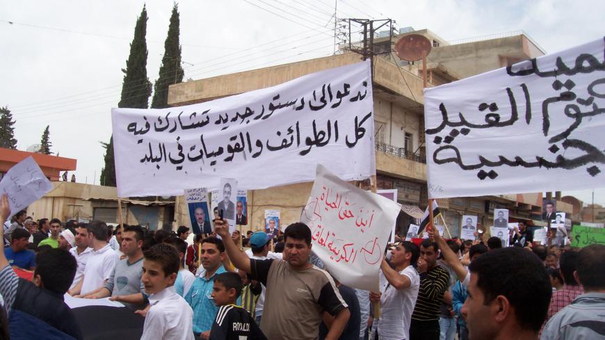 Syrian ethnic Kurds demonstrate after Friday prayers in the Syrian town of Qamishli May 6, 2011. The banner reads "We call for a new constitution in which all sects and nationalities in the country can participate".   REUTERS/Handout (SYRIA - Tags: POLITICS CIVIL UNREST) THIS IMAGE HAS BEEN SUPPLIED BY A THIRD PARTY. IT IS DISTRIBUTED, EXACTLY AS RECEIVED BY REUTERS, AS A SERVICE TO CLIENTS - RTR2M2TY