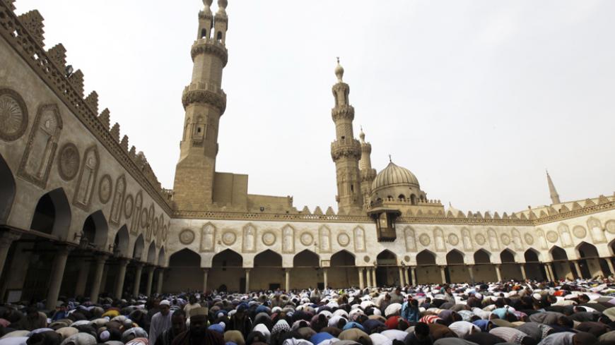People perform Friday prayers led by Chairman of the International Union of Muslim Scholars Egyptian Cleric Sheikh Yusuf al-Qaradawi at Al Azhar mosque in old Cairo November 16, 2012. Egyptian President Mohamed Mursi denounced Israel's attacks on the Gaza Strip as "a blatant aggression against humanity" and said Cairo "would not leave Gaza on its own", the state news agency MENA reported.REUTERS/Amr Abdallah Dalsh  (EGYPT - Tags: POLITICS CIVIL UNREST RELIGION) - RTR3AHHI