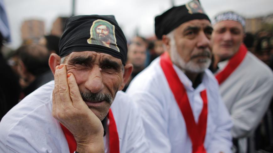 Shi'ite men attend an Ashura procession in Istanbul November 24, 2012. Ashura, the most important day in the Shi'ite calendar, commemorates the death of Imam Hussein, grandson of the Prophet Mohammad, in the seventh century battle of Kerbala. REUTERS/Murad Sezer (TURKEY - Tags: ANNIVERSARY RELIGION) - RTR3ATPL