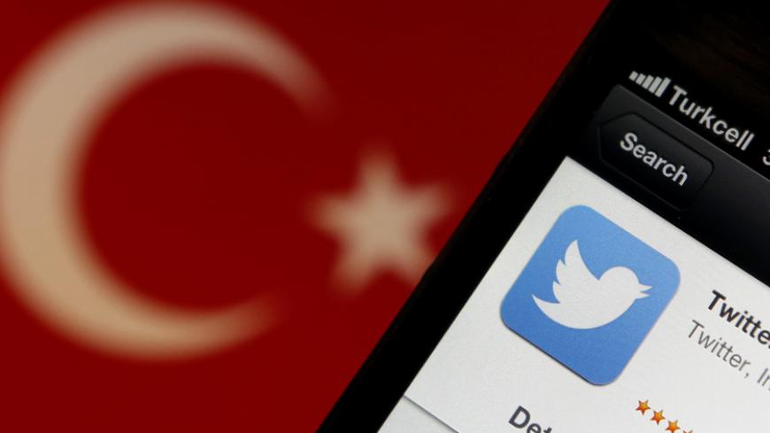 A Twitter logo on an iPhone display is pictured next to a Turkish flag in this photo illustration taken in Istanbul March 21, 2014. Turkey's courts have blocked access to Twitter a little over a week before elections as Prime Minister Tayyip Erdogan battles a corruption scandal that has seen social media awash with alleged evidence of government wrongdoing. The ban came hours after a defiant Erdogan, on the campaign trail ahead of key March 30 local elections, vowed to "wipe out" Twitter and said he did not