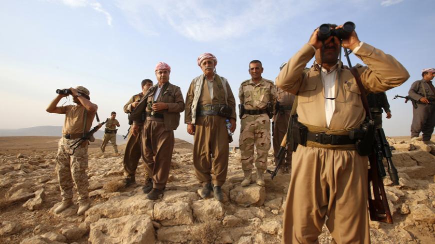 Kurdish Peshmerga forces stand guard near the town of Makhmur, south of Erbil, capital of Iraqi Kurdistan after Islamic State (IS) insurgents withdrew August 18, 2014. REUTERS/Youssef Boudlal (IRAQ - Tags: CIVIL UNREST POLITICS MILITARY TPX IMAGES OF THE DAY) - RTR42VDS