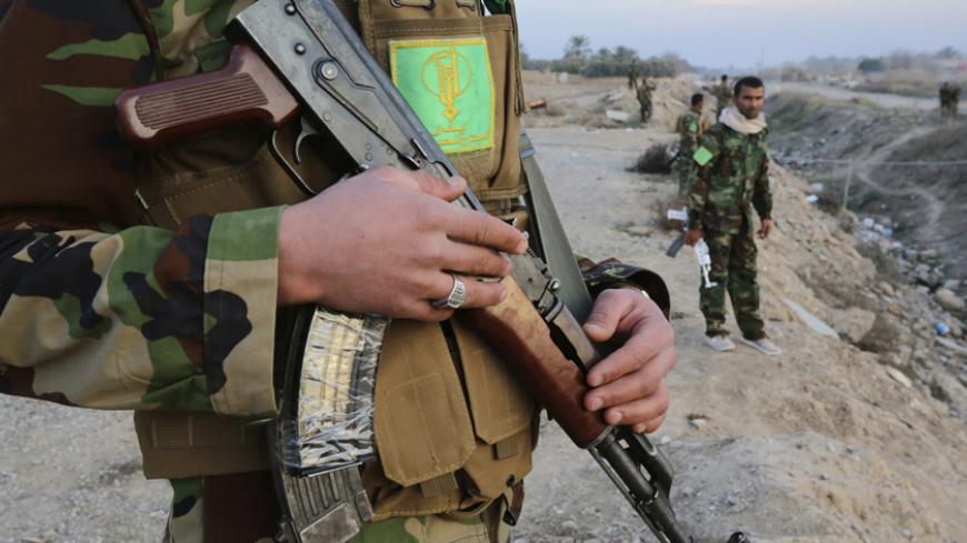 A Shi'ite fighter holds his weapon while guarding on the outskirts of Diyala province, north of Baghdad February 2, 2015.Picture taken February 2, 2015. REUTERS/Stringer (IRAQ - Tags: CIVIL UNREST POLITICS MILITARY CONFLICT) - RTR4O0KC