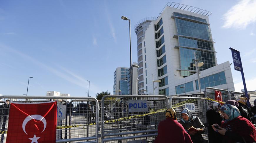 Supporters of the Gulen movement read the Koran as they gather in front of the Bank Asya headquarters in Istanbul February 4, 2015. Turkey has taken control of Bank Asya, the Islamic lender caught up in a feud between President Tayyip Erdogan and his ally-turned-foe, U.S.-based Muslim cleric Fethullah Gulen. The action by Turkey's banking regulatory authorities follows a run on deposits at Bank Asya last year when the lender became embroiled in the power struggle between Erdogan and Gulen, whose followers h