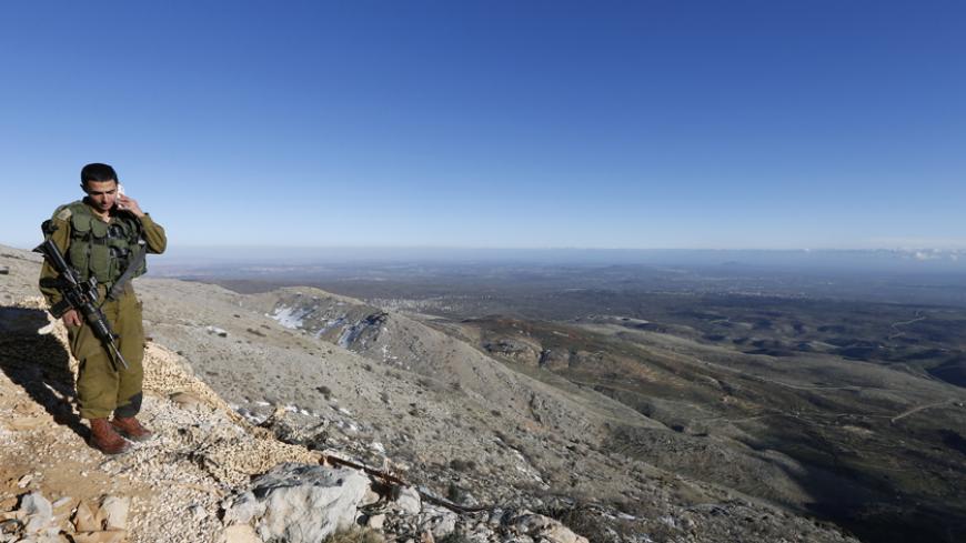 An Israeli soldier speaks on his mobile phone at a military outpost on Mount Hermon in the Golan Heights over looking the Israel-Syria border February 4, 2015. REUTERS/Baz Ratner (ISRAEL - Tags: POLITICS CIVIL UNREST CONFLICT) - RTR4O8R8