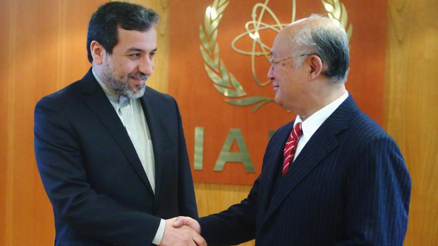 International Atomic Energy Agency (IAEA) Director General Yukiya Amano (R) welcomes Iran's chief nuclear negotiator Abbas Araghchi in his offfice at the IAEA headquarters in Vienna February 24, 2015. REUTERS/Heinz-Peter Bader (AUSTRIA - Tags: POLITICS ENERGY) - RTR4QWK7