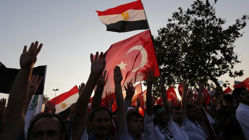 Supporters of Egypt's deposed Islamist President Mohamed Mursi and the Muslim Brotherhood wave Turkish and Egyptian flags during a rally in protest against the recent violence in Egypt, outside of the Eminonu New mosque in Istanbul August 17, 2013. REUTERS/Murad Sezer (TURKEY  - Tags: POLITICS CIVIL UNREST) - RTX12P99