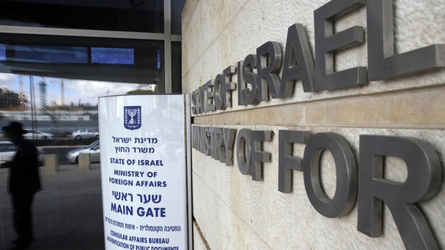 A man is reflected in a window at the entrance to the Israeli Ministry of Foreign Affairs in Jerusalem January 5, 2011. Russia's President Dmitry Medvedev has had to cancel a rare visit to Israel due to a strike at the Israeli foreign ministry, but the strike over pay and working conditions at the ministry, which has foiled three official visits by foreign leaders so far, seems to be having no direct impact on diplomacy aimed at resuscitating Israeli-Palestinian peace. REUTERS/Ronen Zvulun (JERUSALEM - Tags