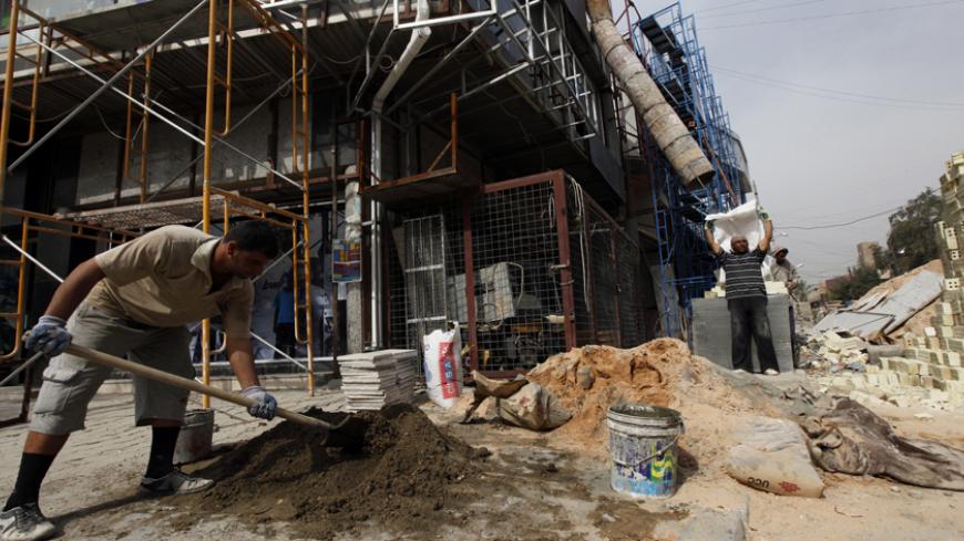Labourers work at a construction site in Karrad district in Baghdad April 3, 2013. Thanks to a partial improvement of security and an oil boom, Iraqis' average incomes are rising sharply, and they are able to save more. But many of these savings are not being channelled into the stock market, where they could earn returns, or even into bank deposits, where they could be lent on to companies for fresh investment. Instead, they are going into real estate. REUTERS/Mohammed Ameen (IRAQ - Tags: BUSINESS REAL EST