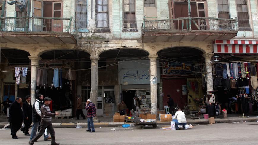 Iraqis walk past a traditional building in the oldest alley of the capital Baghdad on December 13, 2013. Baghdad was once the capital of an empire and the centre of the Islamic world, but at 1,250 years old, the Iraqi city is a far cry from its past glories after being ravaged by years of war and sanctions. AFP PHOTO/AHMAD AL-RUBAYE        (Photo credit should read AHMAD AL-RUBAYE/AFP/Getty Images)