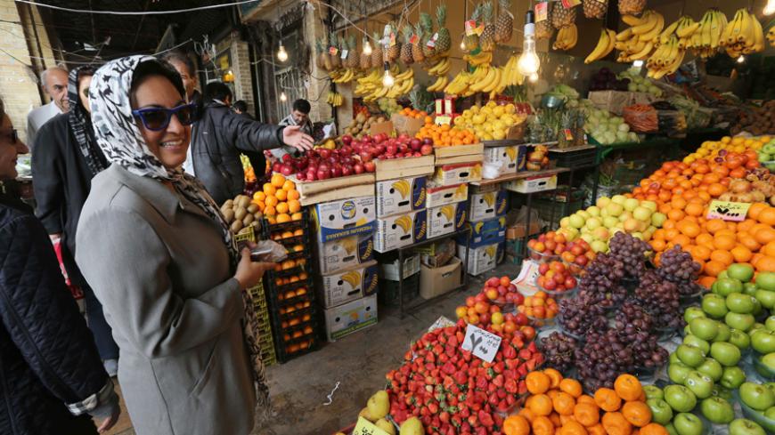 Iranians shop for Noruz, the Persian New Year, at a market in Tehran on 19 March 2014. Iranians are preparing to celebrate Noruz, an ancient Zoroastrian feast starting 21 March, by buying flowers, green plants and goldfish. Noruz is calculated according to a solar calendar, this year marking 1393. AFP PHOTO/ATTA KENARE        (Photo credit should read ATTA KENARE/AFP/Getty Images)