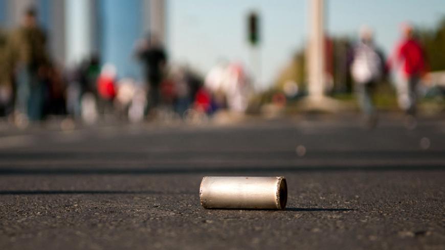 A tear gas canister is seen on the ground after anti-government protesters pushed through security forces to retake Pearl Sqaure in Manama February 19, 2011. Anti-government protesters in Bahrain swarmed back into the symbolic Pearl Square on Saturday, putting riot police to flight in a striking victory for their cause.            REUTERS/James Lawler Duggan (BAHRAIN - Tags: POLITICS CIVIL UNREST) - RTR2ITOT
