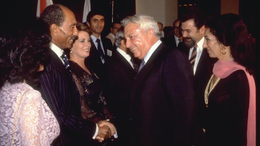 Israel's Agricultural Minister Ariel Sharon (3rd R) shakes hands with Egypt's President Anwar Sadat in the northern city of Haifa in this handout file picture taken September 4, 1979 and released by the Israeli Government Press Office (GPO). 
REUTERS/Yaacov Saar/GPO/Handout/Files (ISRAEL - Tags: POLITICS) FOR EDITORIAL USE ONLY. NOT FOR SALE FOR MARKETING OR ADVERTISING CAMPAIGNS. THIS IMAGE HAS BEEN SUPPLIED BY A THIRD PARTY. IT IS DISTRIBUTED, EXACTLY AS RECEIVED BY REUTERS, AS A SERVICE TO CLIENTS. ISRAE