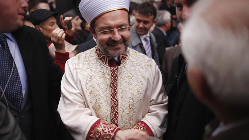 Grand Mufti of Turkey Mehmet Gormez shakes hands with a onlooker after an inauguration ceremony in front of the Gazi Husrev Begova mosque in Sarajevo, November 15, 2012. Newly elected Husein Kavazovic is the 14th Grand Mufti of the Islamic Community in Bosnia and Herzegovina and will be on duty over the next seven years. REUTERS/Dado Ruvic (BOSNIA AND HERZEGOVINA - Tags: SOCIETY RELIGION) - RTR3AFY0