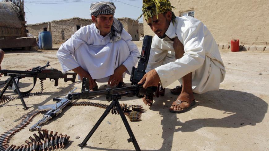 Shi'ite volunteers, who have joined the Iraqi army to fight against the predominantly Sunni militants from the radical Islamic State, formerly known as the Islamic State of Iraq and the Levant (ISIL), take part in weapons training in Najaf, July 18, 2014. The United Nations accused Islamic State fighters in Iraq of executions, rape and forced recruitment of children during a campaign to seize much of northern Iraq, part of a conflict it said has killed almost 5,600 civilians this year.  REUTERS/Alaa Al-Marj