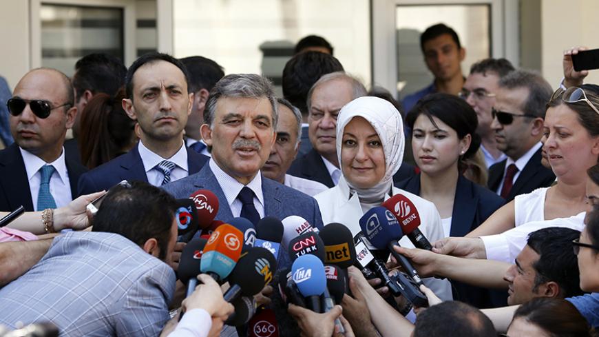 Turkey's incumbent President Abdullah Gul and his wife Hayrunnisa Gul talk to the media as they leave a polling station after casting their votes in Ankara August 10, 2014. Turks began voting on Sunday with Tayyip Erdogan poised to become the country's first elected president, fulfilling his dream of what he calls a "new Turkey" and his opponents say will be an increasingly authoritarian nation. REUTERS/Umit Bektas (TURKEY - Tags: POLITICS ELECTIONS) - RTR41UXL