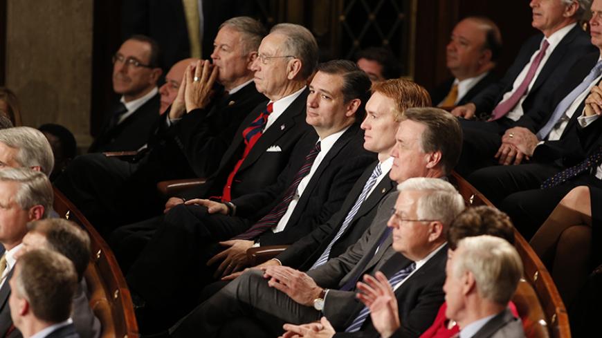 U.S. Rep. Ted Cruz (R-TX) (C) and Republican congressional colleagues listen as U.S. President Barack Obama delivers his State of the Union address to a joint session of the U.S. Congress on Capitol Hill in Washington, January 20, 2015. REUTERS/Larry Downing (UNITED STATES - Tags: POLITICS) - RTR4M87B