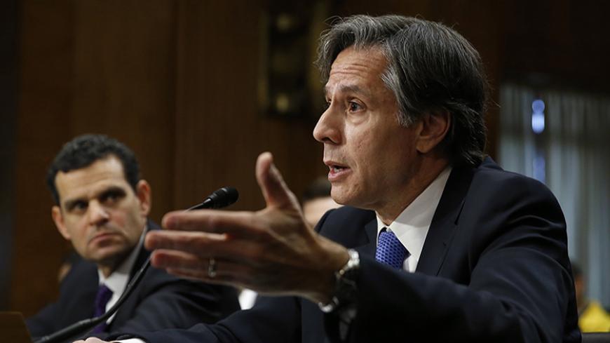 U.S. Deputy Secretary of State Antony Blinken (R) and Treasury Under Secretary for Terrorism and Financial Intelligence David Cohen (L) testify before the Senate Foreign Relations Committee in Washington January 21, 2015. Top U.S. Treasury and State Department officials said on Wednesday that, despite reports, Russia had not entered into oil-for-goods deals with Iran in violation of international sanctions. REUTERS/Gary Cameron (UNITED STATES - Tags: POLITICS BUSINESS) - RTR4MCBJ