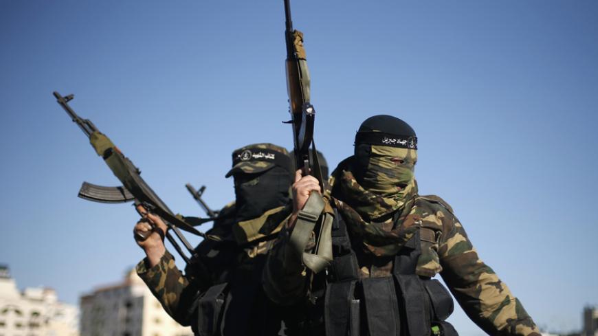 Palestinians militants leave after representatives of various Palestinian armed factions held a news conference to condemn the decision of an Egyptian court that banned Hamas' armed wing, in Gaza City February 5, 2015. An Egyptian court last week banned Hamas' armed wing and listed it as a terrorist organization, prompting Hamas to reject Egypt as a mediator between Israel and the Palestinians, a role it has played for decades. 
REUTERS/Suhaib Salem (GAZA - Tags: POLITICS MILITARY CIVIL UNREST) - RTR4OC6I