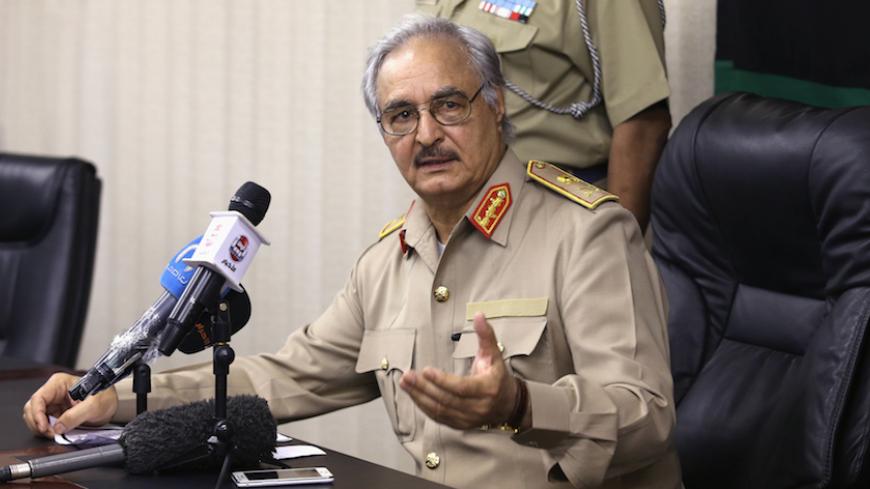 Then-General Khalifa Haftar speaks during a news conference in Abyar, east of Benghazi May 31, 2014. Growing frustration over the reality of life in eastern Libya, which contrasts with the promises of politicians, is feeding support for Haftar, who has set himself up as a warrior against Islamist militancy and who some also see as their saviour. Picture taken May 31, 2014. REUTERS/Esam Omran Al-Fetori (LIBYA - Tags: CIVIL UNREST POLITICS MILITARY) - RTR4QLUA