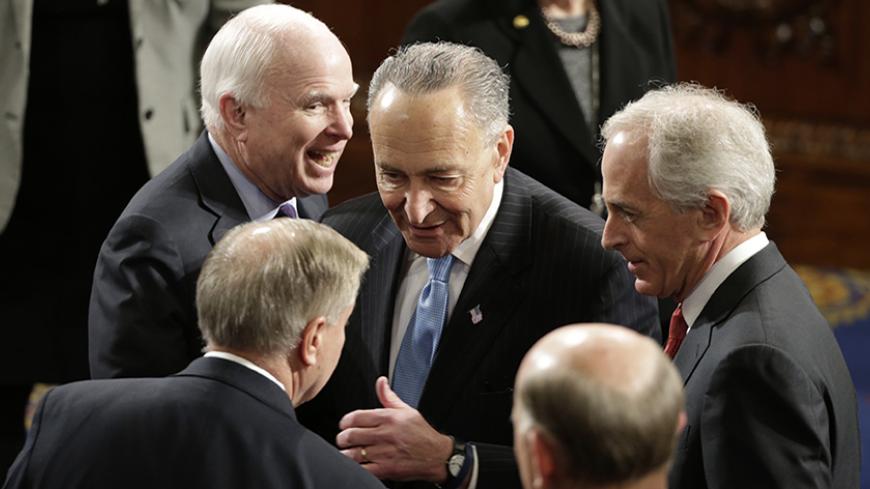 U.S. Senators' Lindsey Graham (front L) (R-SC), John McCain (Back L) (R-AZ), Charles Schumer (C) (D-NY) and Bob Corker (R) (R-TN) talk on the floor of the House Chamber prior to Israeli Prime Minister Benjamin Netanyahu's address to a joint meeting of Congress in the House Chamber on Capitol Hill in Washington, March 3, 2015. REUTERS/Gary Cameron (UNITED STATES  - Tags: POLITICS)   - RTR4RX59