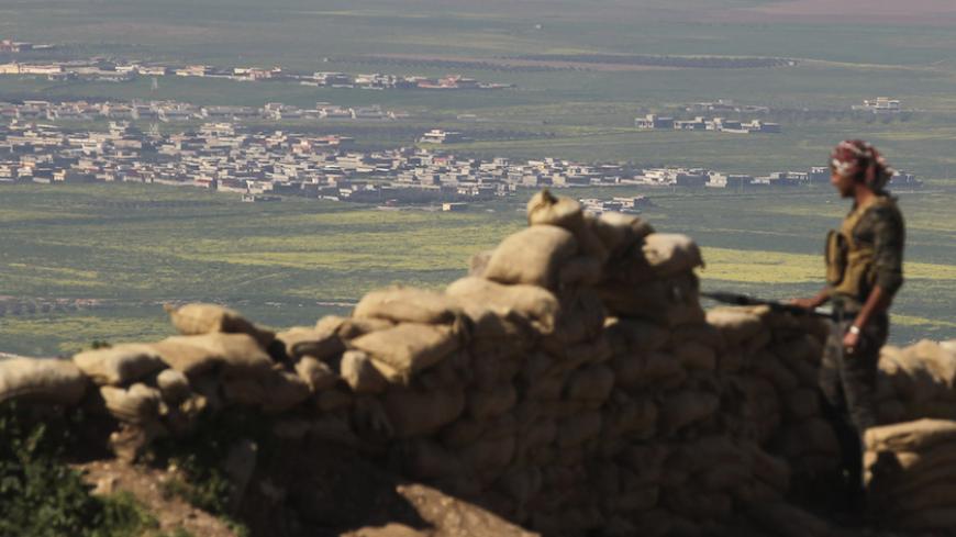 A member of the Kurdish Peshmerga forces stands guard at a security point on Bashiqa mountain, overlooking Islamic State held territories of Mosul, 12 km northeast of Mosul City, March 7, 2015. REUTERS/Asmaa Waguih (IRAQ - Tags: POLITICS MILITARY CONFLICT) - RTR4SF1J