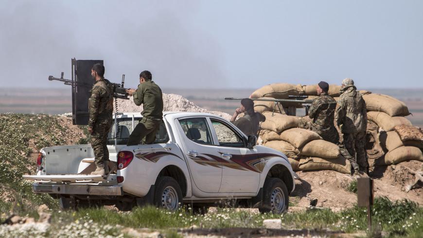 Kurdish People's Protection Units (YPG) fighters and foreign fighters (R) who joined the YPG, man their weapons during what the YPG said was an offensive against them by Islamic State fighters, in the western countryside of Ras al-Ain March 10, 2015. Picture taken March 10, 2015. REUTERS/Rodi Said (SYRIA - Tags: POLITICS CIVIL UNREST CONFLICT MILITARY) - RTR4SVQX
