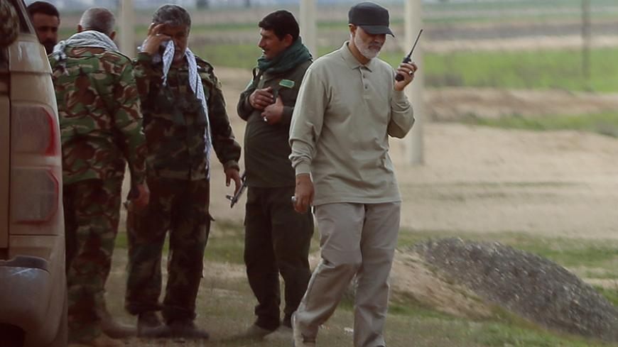 Iranian Revolutionary Guard Commander Qassem Soleimani uses a walkie-talkie at the frontline during offensive operations against Islamic State militants in the town of Tal Ksaiba in Salahuddin province March 8, 2015. Picture taken March 8, 2015.   REUTERS/Stringer (IRAQ - Tags: CIVIL UNREST CONFLICT POLITICS) - RTR4TU0N
