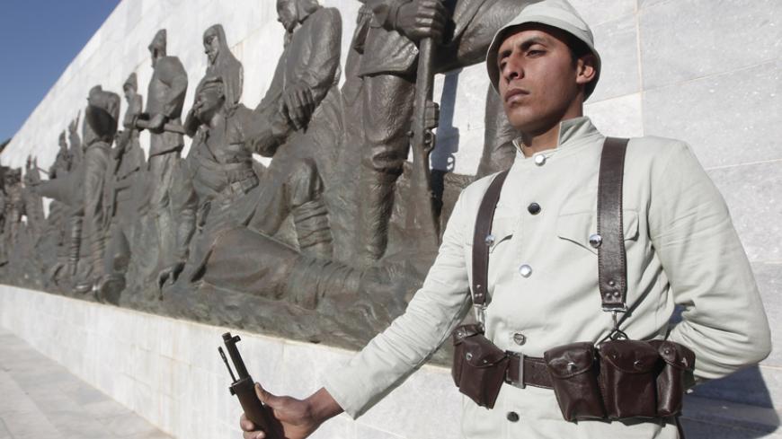 A Turkish soldier in historical uniform stands at a ceremony marking the 100th anniversary of the Battle of Canakkale, as part of the Gallipoli campaign in Gallipoli March 18, 2015. Turkish jets flew overhead and warships cut through rough waters in the Dardanelles Straits on Wednesday to mark the centenary of one of the Ottoman Empire's final victories, as fascination with the imperial past flourishes under President Tayyip Erdogan. Record numbers of Turks have flocked to these headlands in recent years to
