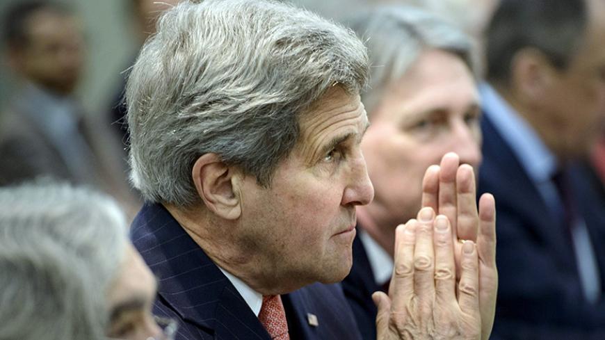 U.S. Secretary of State John Kerry waits with others before a meeting with P5+1, European Union and Iranian officials at the Beau Rivage Palace Hotel in Lausanne March 30, 2015, during Iran nuclear talks.  REUTERS/Brendan Smialowski/Pool   - RTR4VF2S