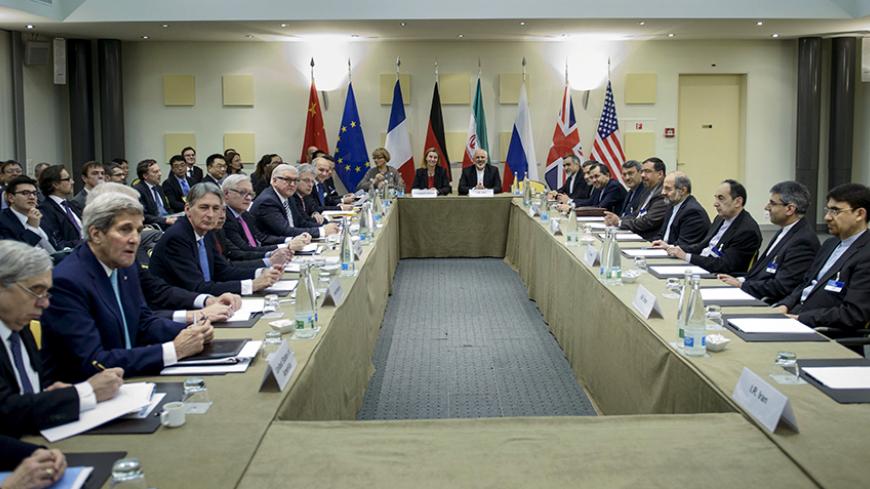 Officials wait for a meeting with officials from P5+1, the European Union and Iran at the Beau Rivage Palace Hotel in Lausanne March 31, 2015.  REUTERS/Brendan Smialowski/Pool - RTR4VJX4