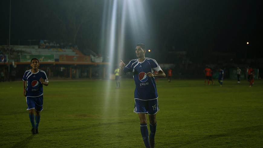 Palestinian Mohammed Sedody (R) of Shati club celebrates his goal against Khan Younis youth club during their semi-final soccer match as part of the local Ramadan soccer championship at Yarmouk stadium in Gaza City August 1, 2013. REUTERS/Mohammed Salem (GAZA - Tags: SPORT SOCCER) - RTX127P6
