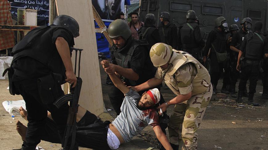 ATTENTION EDITORS - VISUAL COVERAGE OF SCENES OF INJURY OR DEATH

An injured member of the Muslim Brotherhood and supporter of deposed Egyptian President Mohamed Mursi is carried by members of the riot police and the army after they cleared Rabaa Adawiya square area, where the Pro-Mursi supporters are camping, in Cairo August 14, 2013. Egyptian security forces killed at least 30 people on Wednesday when they cleared a camp of Cairo protesters who were demanding the reinstatement of Mursi, his Muslim Brother