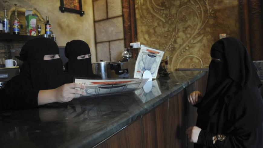 Veiled Saudi women work at a coffee shop in Tabuk, 1500 km (932 miles) from Riyadh November 30, 2013. Saudi Arabia's crackdown on foreign workers has thrown millions of lives into turmoil and caused rioting in big cities, but the economy should benefit in the long run as Saudi nationals fill the gaps and cut their dependence on the state. REUTERS/Mohamed Alhwaity (SAUDI ARABIA - Tags: BUSINESS SOCIETY EMPLOYMENT) - RTX15YWV