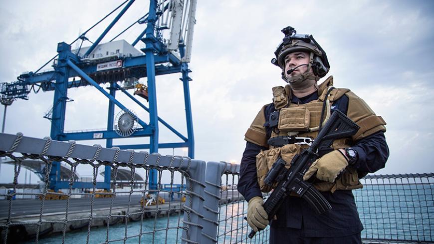 A guard looks on as the Norwegian frigate "Helge Ingstad" leaves the port of Limassol in Cyprus December 28, 2013. The vessel is part of the Danish-Norwegian force that will transport Syria's chemical agents out of the country to destruction. The force is ready for a quick response when they get the green light to go into Syria. Picture taken December 28, 2013.   
    REUTERS/Lars Magne Hovtun/Norwegian Armed Forces/NTB Scanpix    (CYPRUS - Tags: MILITARY TRANSPORT POLITICS) ATTENTION EDITORS - THIS IMAGE H