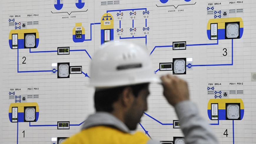 EDITORS' NOTE: Reuters and other foreign media are subject to Iranian restrictions on their ability to film or take pictures in Tehran.

An Iranian operator monitors the nuclear power plant unit in Bushehr, about 1,215 km (755 miles) south of Tehran, November 30, 2009. Russia plans to start up Iran's first nuclear power station in March 2010 to coincide with the Iranian New Year, two sources closely involved with the project told Reuters. Russia agreed in 1995 to build the 1,000 megawatt nuclear power plant