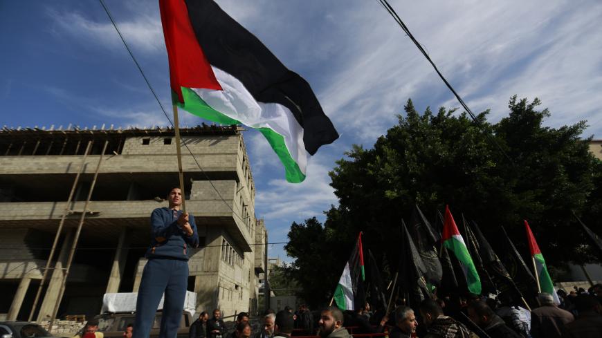 Palestinian men take part in a demonstration is support of Palestinian prisoners held in Israeli jails, on Decembre 11, 2014 in Gaza City. Israel's parliament has passed a law that could block the release in any future peace negotiations of Palestinian prisoners convicted of murder, a spokesman said. AFP PHOTO / MOHAMMED ABED        (Photo credit should read MOHAMMED ABED/AFP/Getty Images)